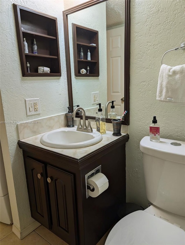 bathroom with a textured wall, vanity, a textured ceiling, and tile patterned floors