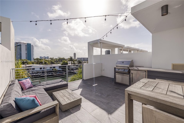 view of patio / terrace featuring grilling area, outdoor lounge area, and a balcony