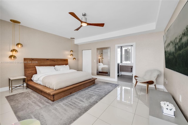 tiled bedroom with connected bathroom and ceiling fan