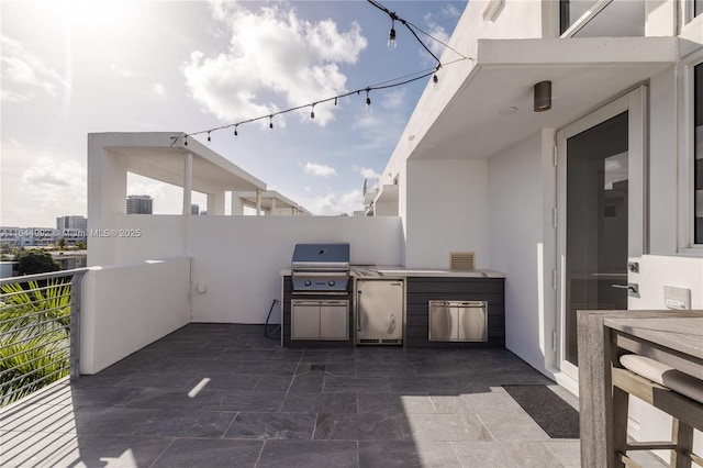 view of patio / terrace with a balcony and area for grilling