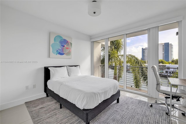 bedroom featuring tile patterned flooring and access to exterior