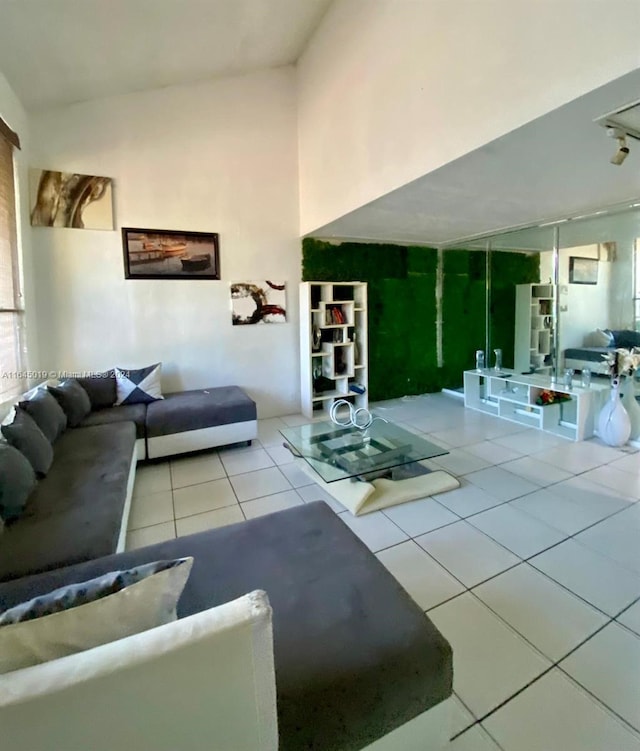 living room with light tile patterned floors and vaulted ceiling