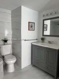 12124 Saint Andrews Pl Unit 112, Miramar, FL 33025 - bathroom featuring vanity and tile walls