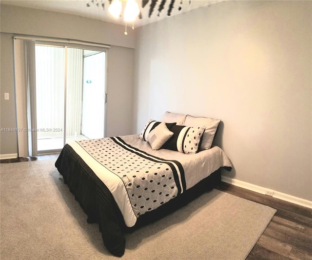 bedroom featuring access to exterior and wood-type flooring