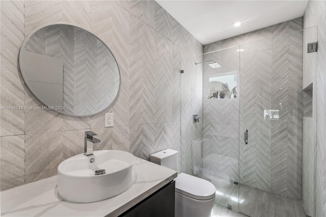 bathroom featuring tile walls, toilet, an enclosed shower, and vanity