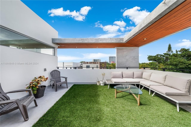 view of yard featuring a balcony and outdoor lounge area