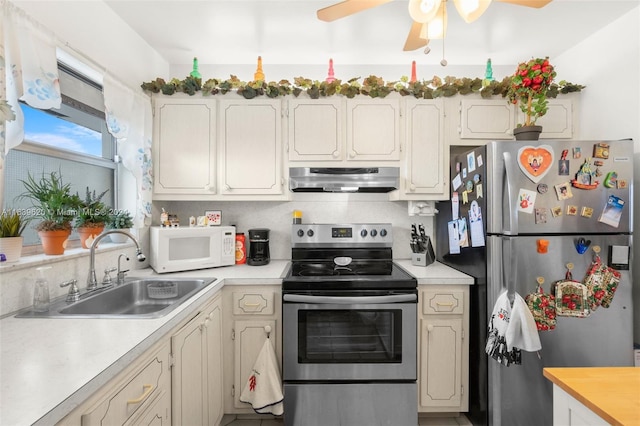 kitchen featuring ceiling fan, sink, backsplash, and appliances with stainless steel finishes