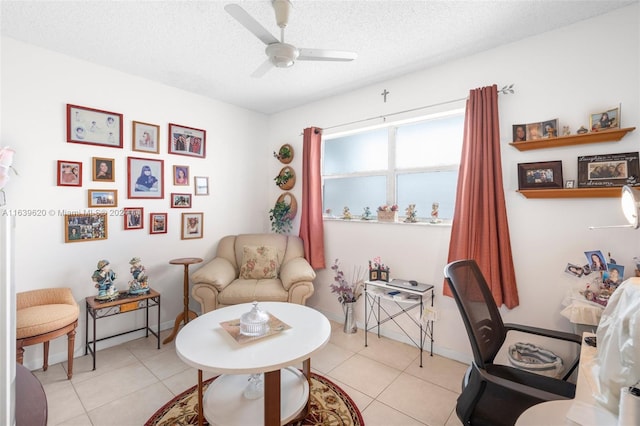 tiled home office with ceiling fan and a textured ceiling