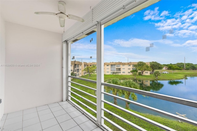 balcony featuring ceiling fan and a water view