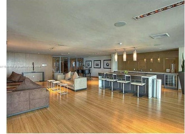 living room featuring wooden walls and hardwood / wood-style flooring