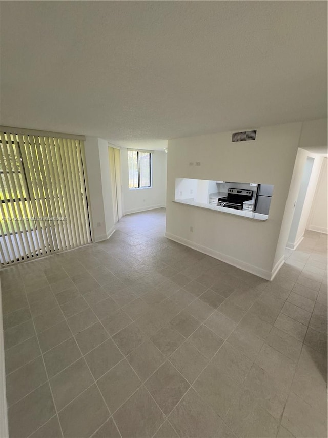 unfurnished living room featuring light tile patterned flooring