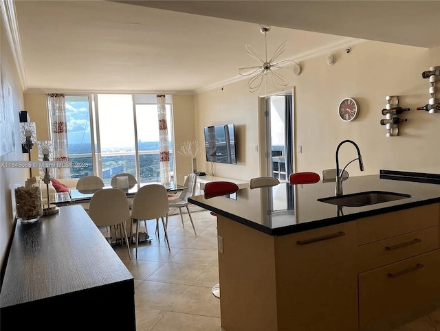 1850 S Ocean Dr Unit 3809, Hallandale Beach, FL 33009 - kitchen with crown molding, light tile patterned floors, floor to ceiling windows, a chandelier, and dark countertops