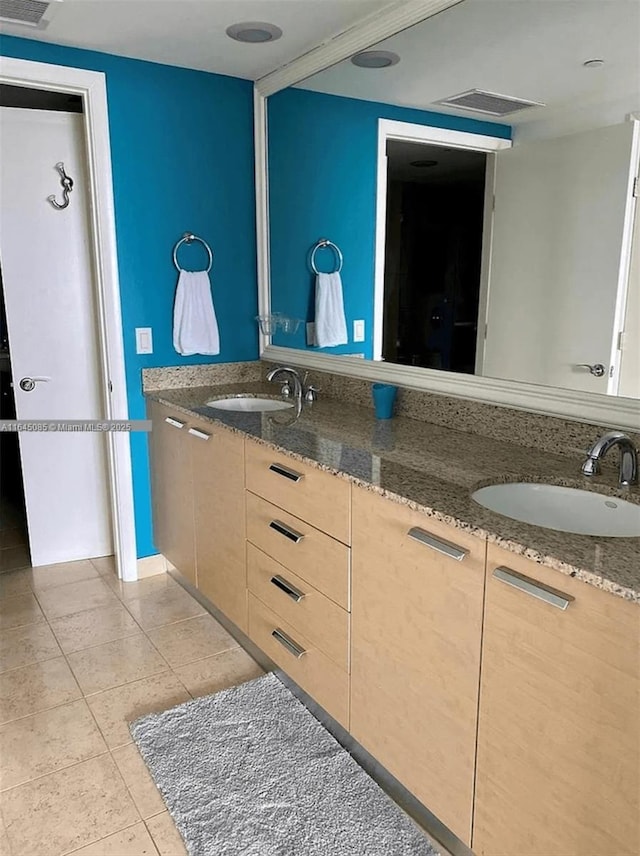 1850 S Ocean Dr Unit 3809, Hallandale Beach, FL 33009 - kitchen featuring dark stone counters, light tile patterned flooring, and light brown cabinetry