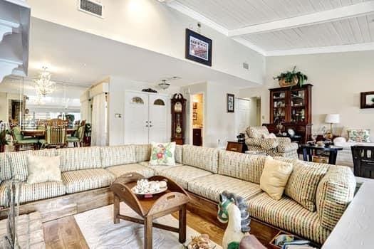 living room with wood ceiling, a high ceiling, wood-type flooring, and beam ceiling