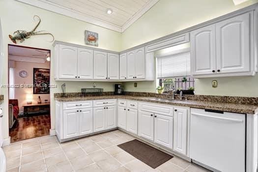 kitchen featuring white cabinets, dishwasher, crown molding, light wood-type flooring, and ceiling fan