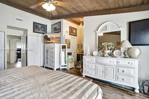 bedroom with wooden ceiling, dark wood-type flooring, and ceiling fan with notable chandelier