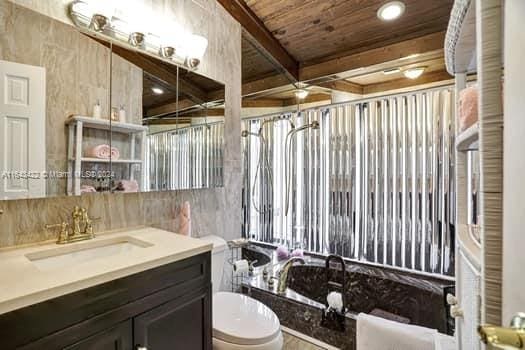 bathroom featuring wood ceiling, vanity, toilet, and beamed ceiling