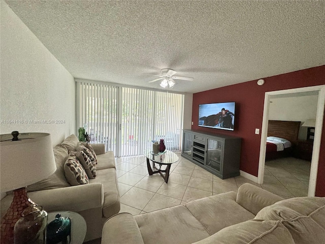 tiled living room with ceiling fan and a textured ceiling