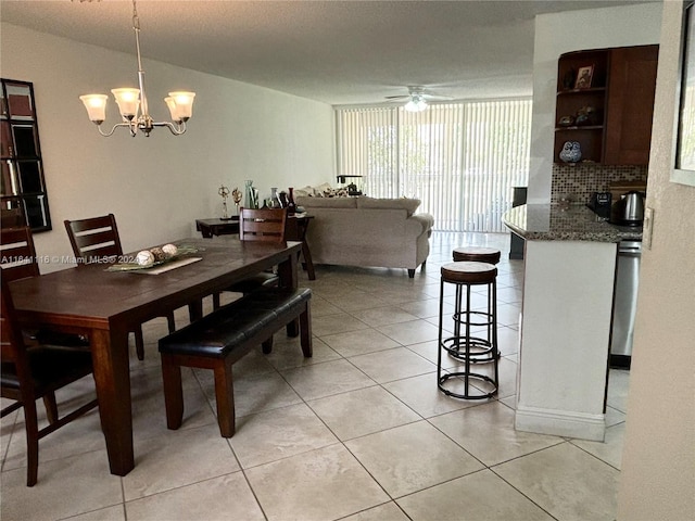 dining room with ceiling fan with notable chandelier and light tile patterned floors