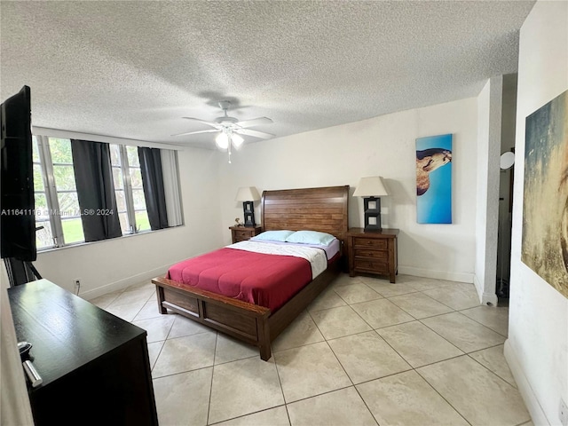 tiled bedroom featuring ceiling fan and a textured ceiling