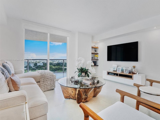 living room featuring light tile patterned floors and floor to ceiling windows