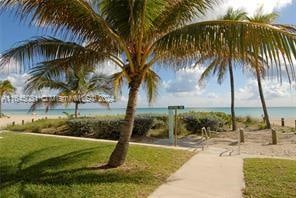 view of community with a yard and a water view