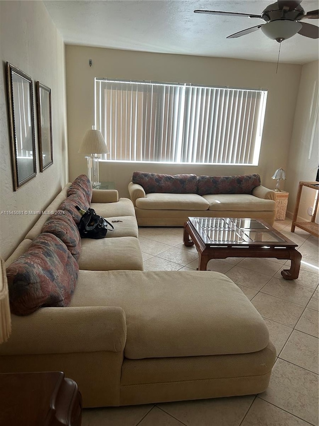 tiled living room with ceiling fan