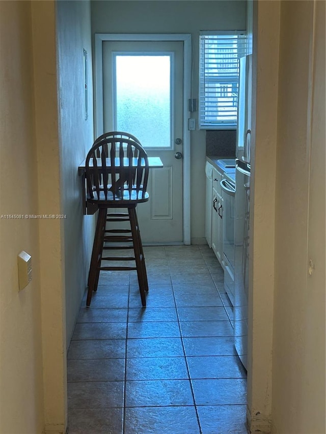 doorway to outside featuring light tile patterned floors