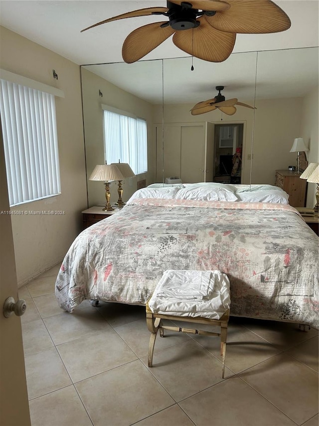 tiled bedroom with ceiling fan