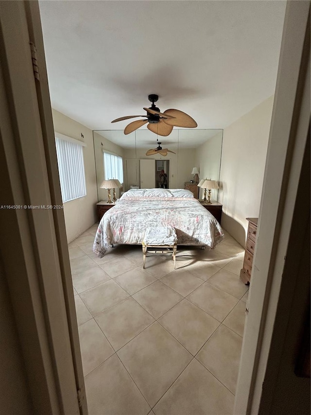 tiled bedroom with ceiling fan