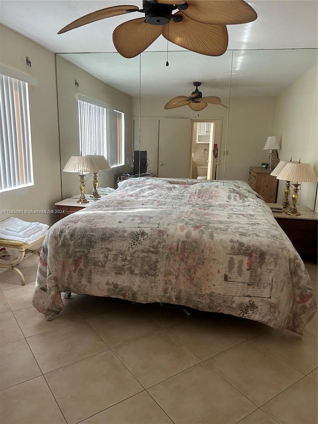 tiled bedroom featuring ceiling fan