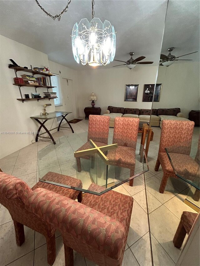 tiled dining area with ceiling fan with notable chandelier