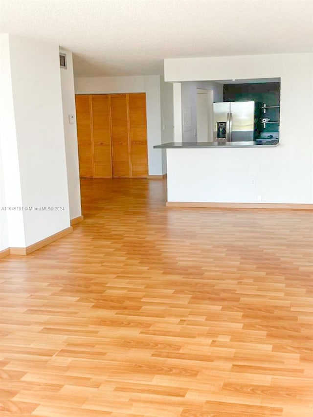 spare room with light wood-type flooring