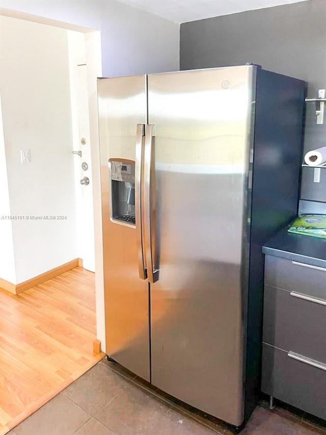 kitchen featuring wood finished floors and stainless steel fridge