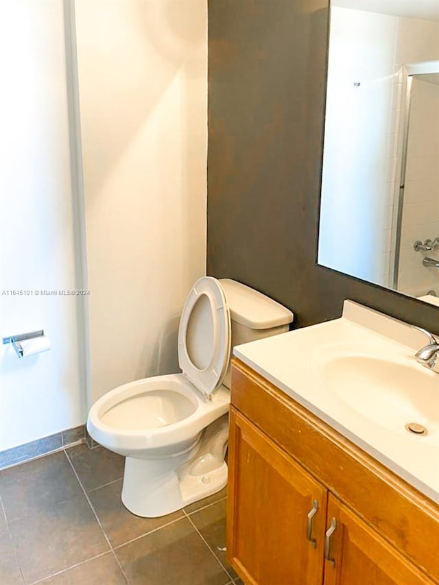 full bathroom featuring walk in shower, toilet, and tile patterned floors