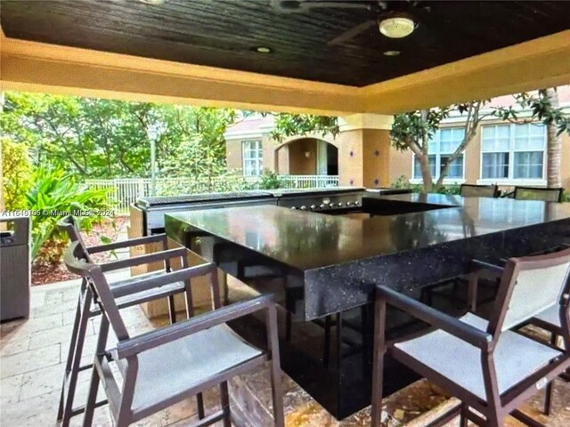 view of patio / terrace with ceiling fan and exterior bar