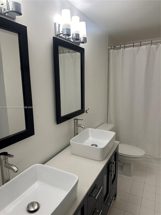 bathroom featuring tile patterned floors, a shower with shower curtain, toilet, and vanity