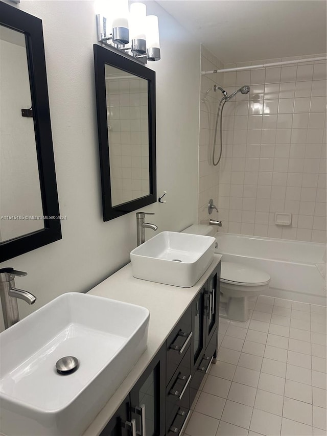 full bathroom with tiled shower / bath, vanity, toilet, and tile patterned flooring