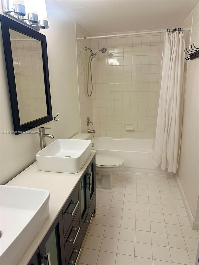 full bathroom with tile patterned flooring, toilet, shower / tub combo, and vanity