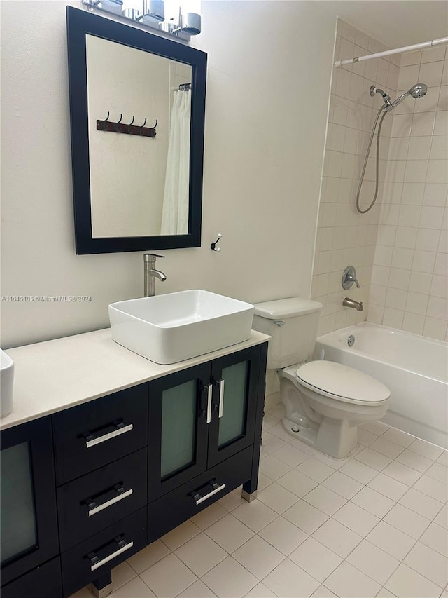 full bathroom featuring shower / bath combo with shower curtain, tile patterned flooring, toilet, and vanity