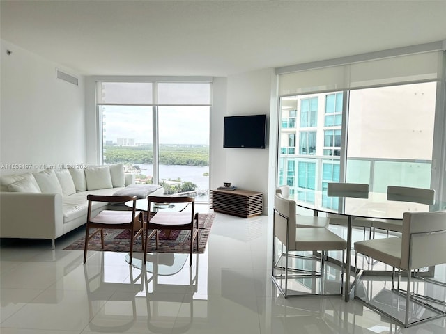 living room featuring floor to ceiling windows and tile patterned floors