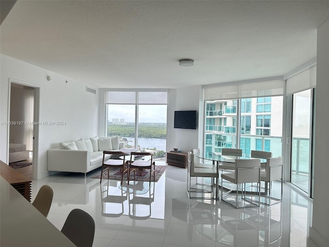 living room featuring light tile patterned floors and expansive windows