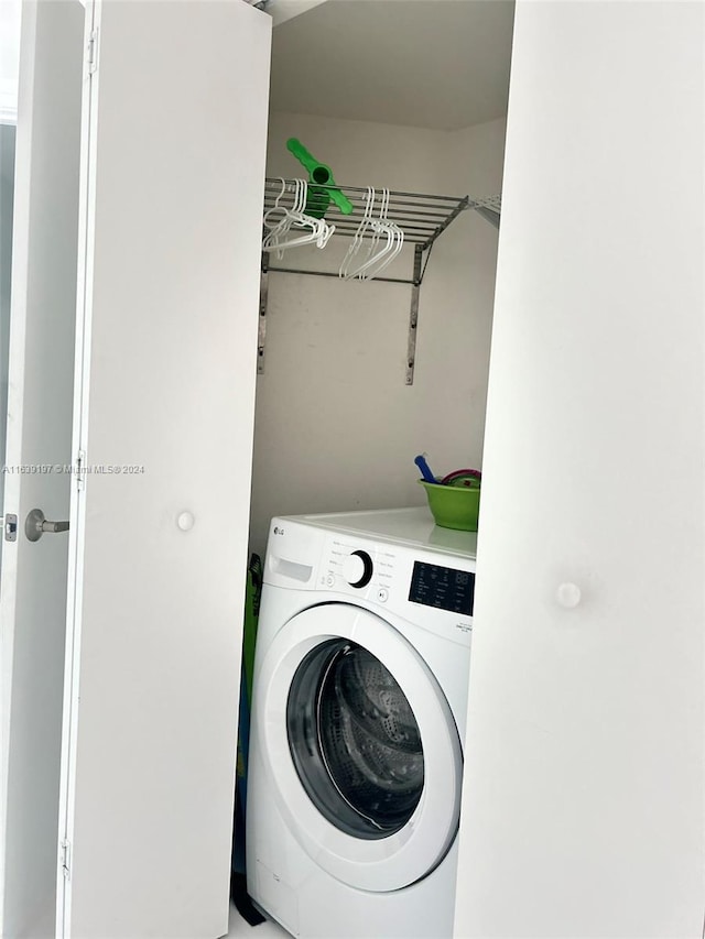 clothes washing area with washer / dryer