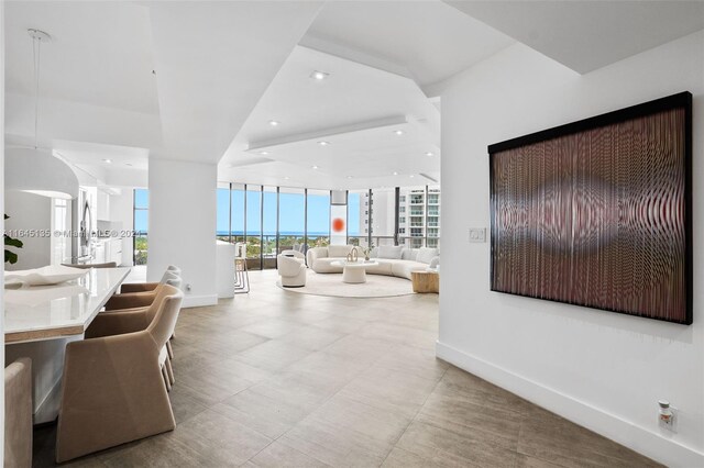 living room featuring expansive windows and light tile patterned floors