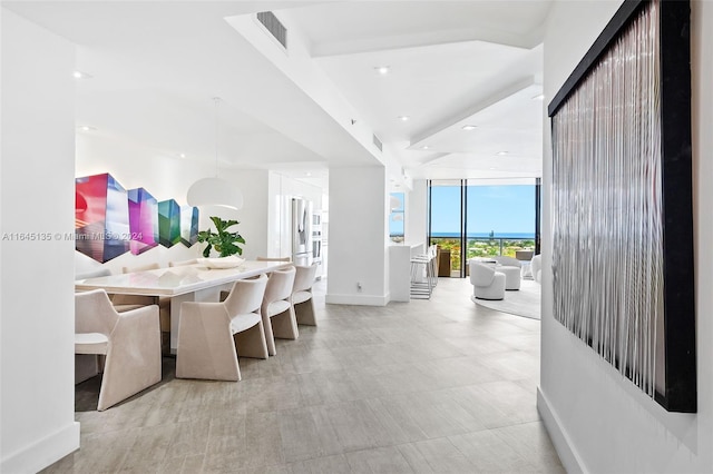 tiled dining room featuring expansive windows