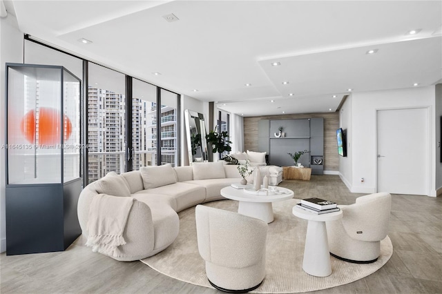 living room with light hardwood / wood-style floors and floor to ceiling windows