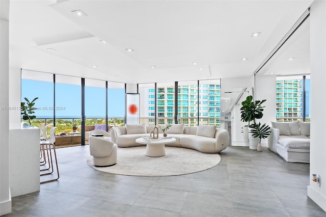 living room featuring floor to ceiling windows, a healthy amount of sunlight, and light tile patterned floors