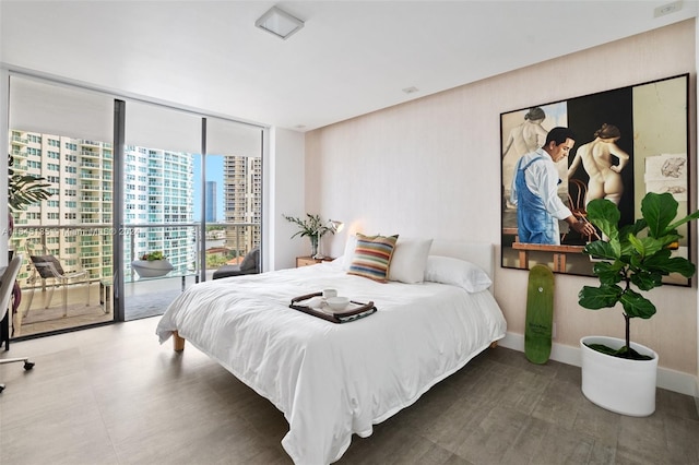 bedroom featuring tile patterned flooring, access to outside, and a wall of windows