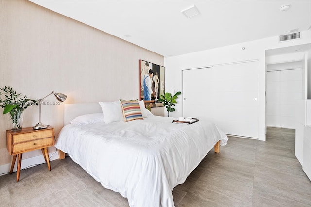 bedroom featuring tile patterned flooring and a closet