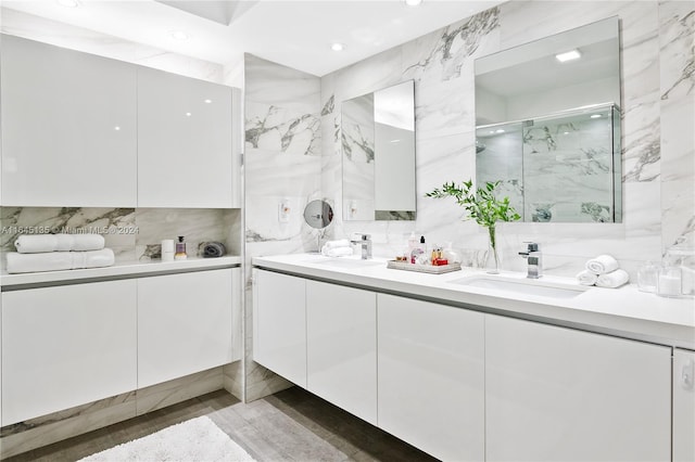 bathroom featuring tile walls, double vanity, and decorative backsplash